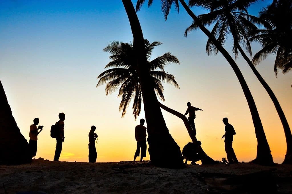 Friends on a Goa beach at sunset
